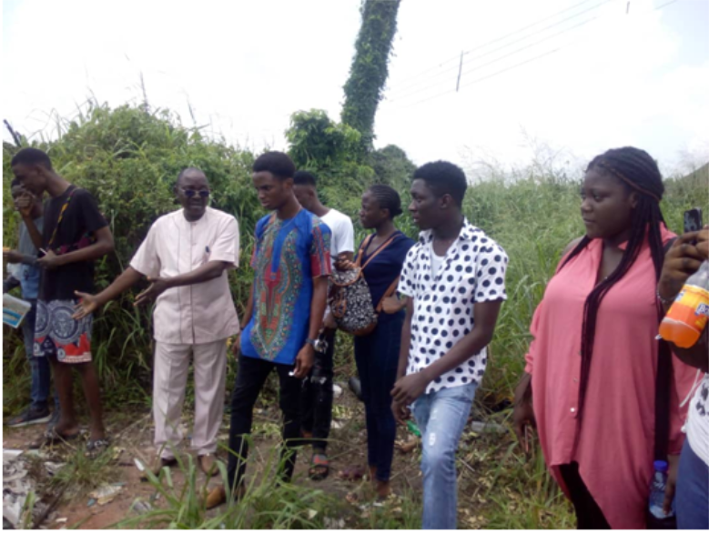 Program Director, Prof I.T. Aighewi at an Erosion site during a field trip with Geography Tutor,